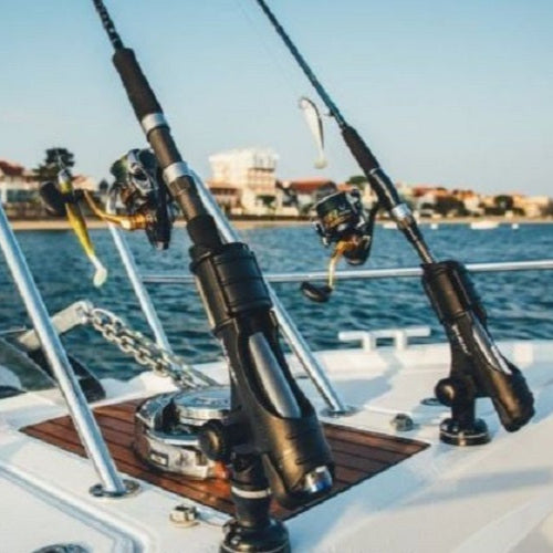 Fishing rods on a boat with water and skyline in the background