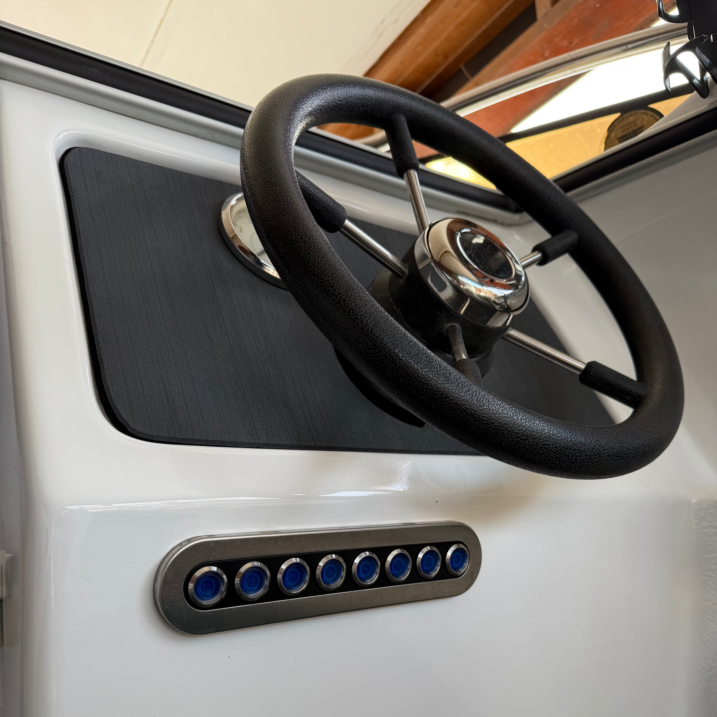 Steering wheel and control panel on a vehicle interior