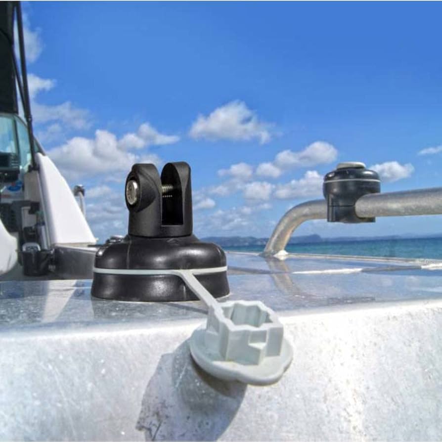 Close-up of a boat's radar system with a clear blue sky and ocean in the background.