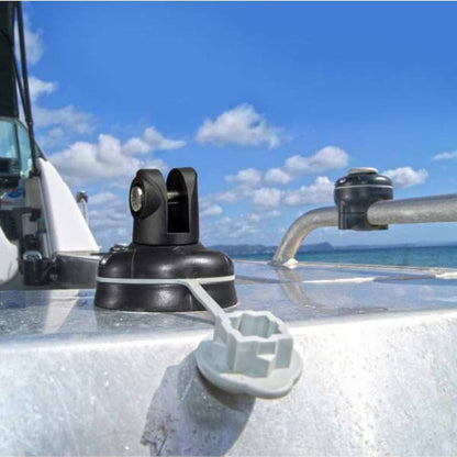 Close-up of a boat's radar system with a clear blue sky and ocean in the background.