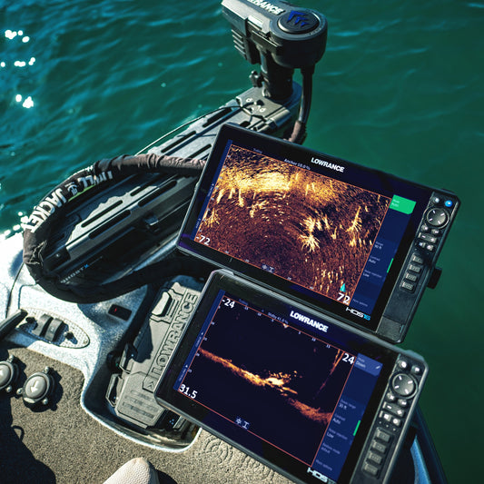 Fishfinder device on a boat with water in the background
