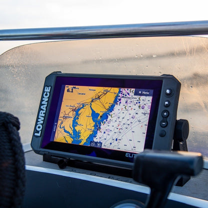 A Lowrance Elite FS fish finder mounted on a boat's console, displaying sonar imaging on the screen.