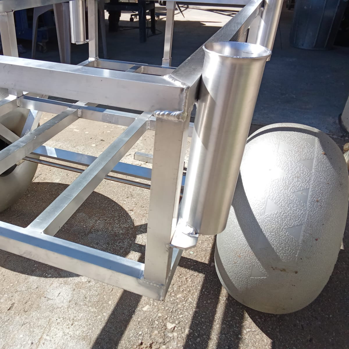 Close up of the rod holders and beach wheels on the 2 wheel beach trolley