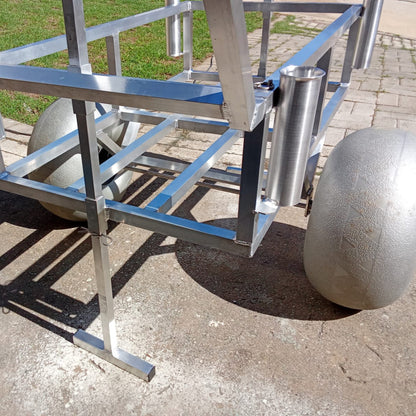 Close up of the rod holders and beach wheels on the 2 wheel beach trolley