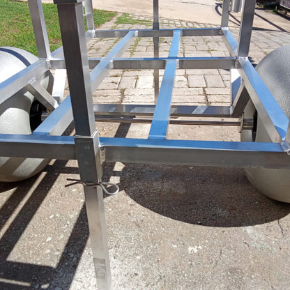 Close up of the rod holders and beach wheels on the 2 wheel beach trolley