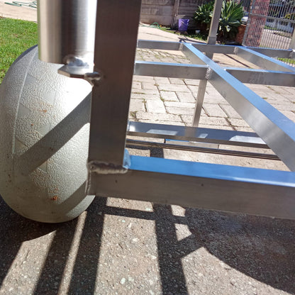 Close up of the rod holders and beach wheels on the 2 wheel beach trolley