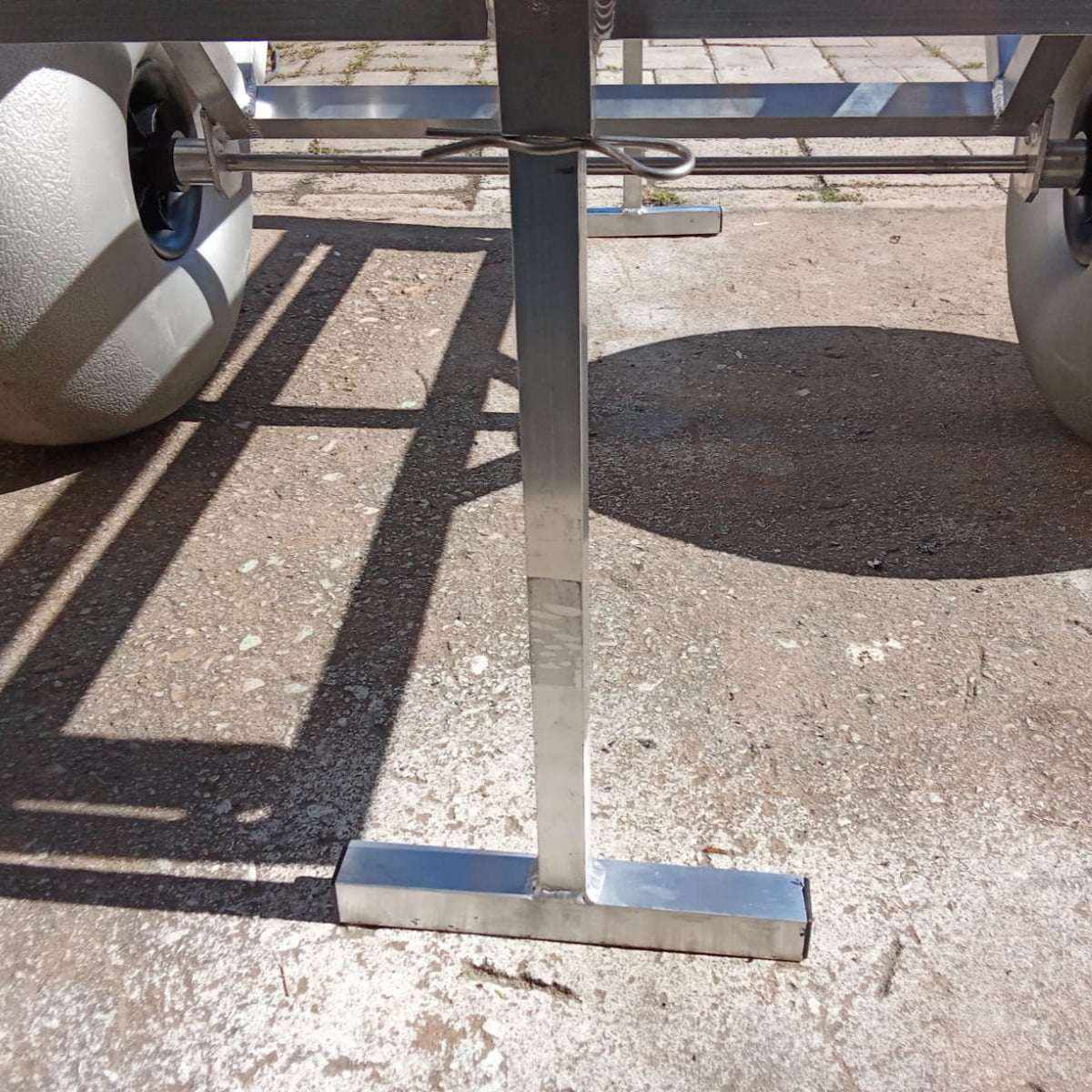 Close up of the rod holders and beach wheels on the 2 wheel beach trolley