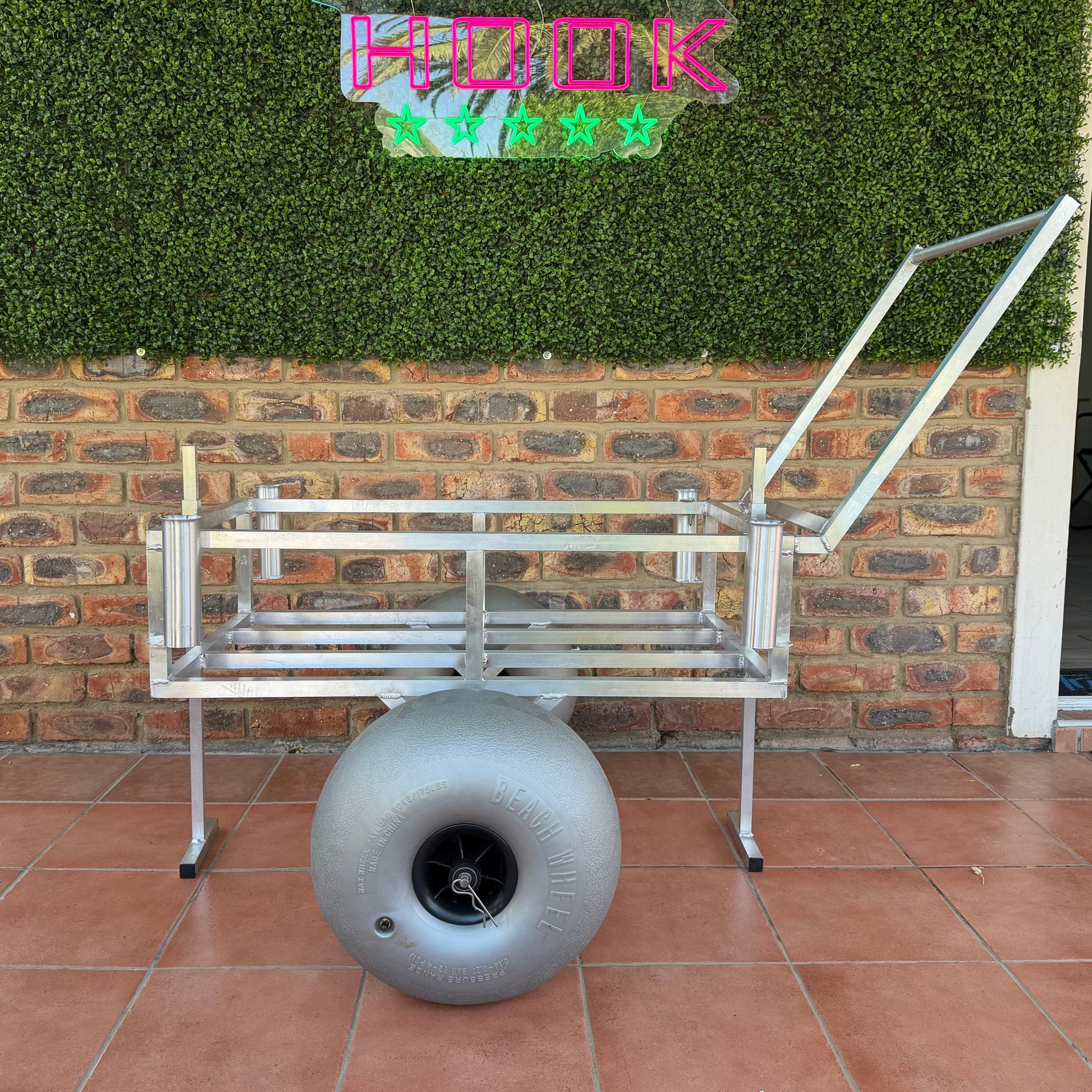 Complete 2 wheel beach trolley with beach wheels with supports open with Tidal Hook logo in the background