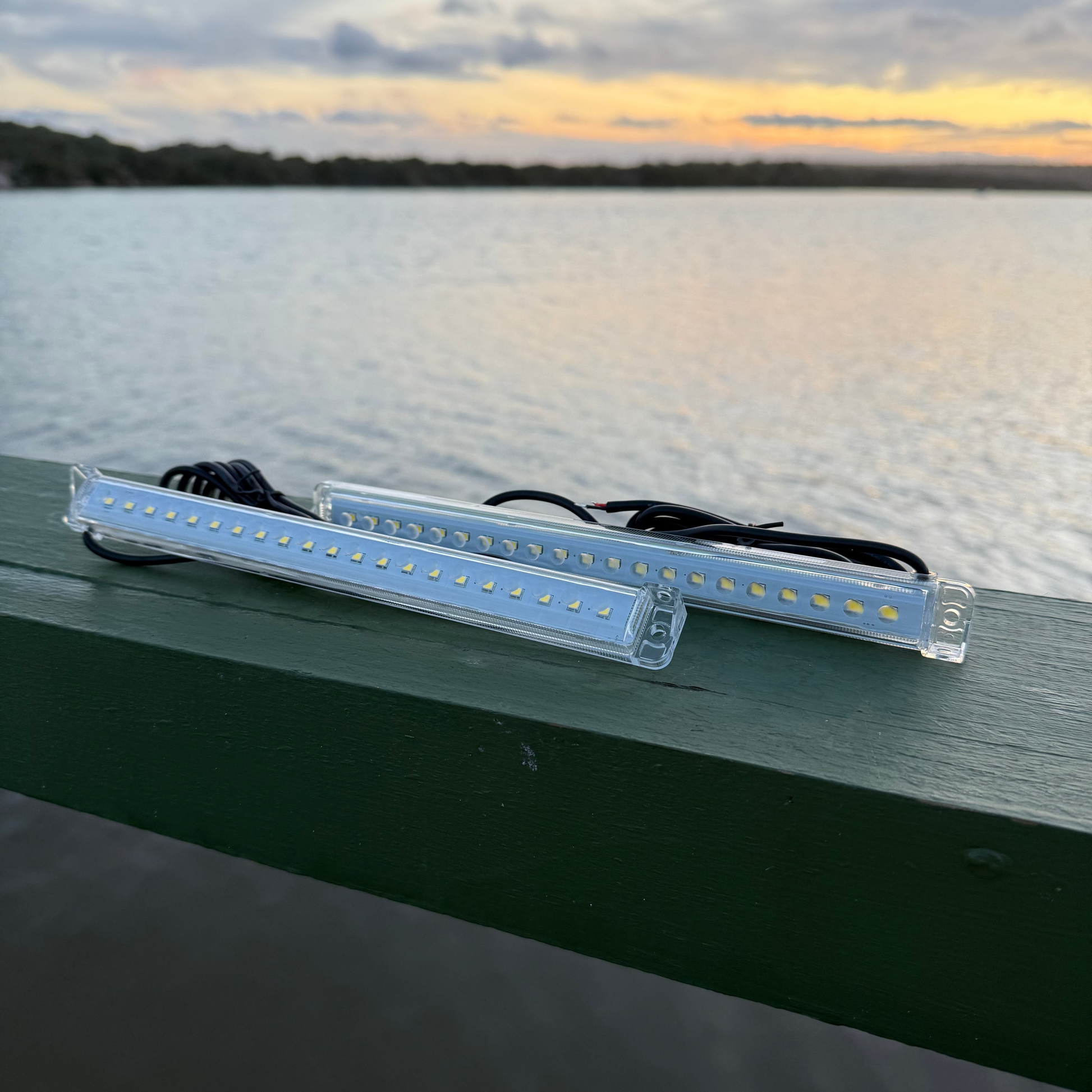 LED light bar on a dock with a sunset over water in the background