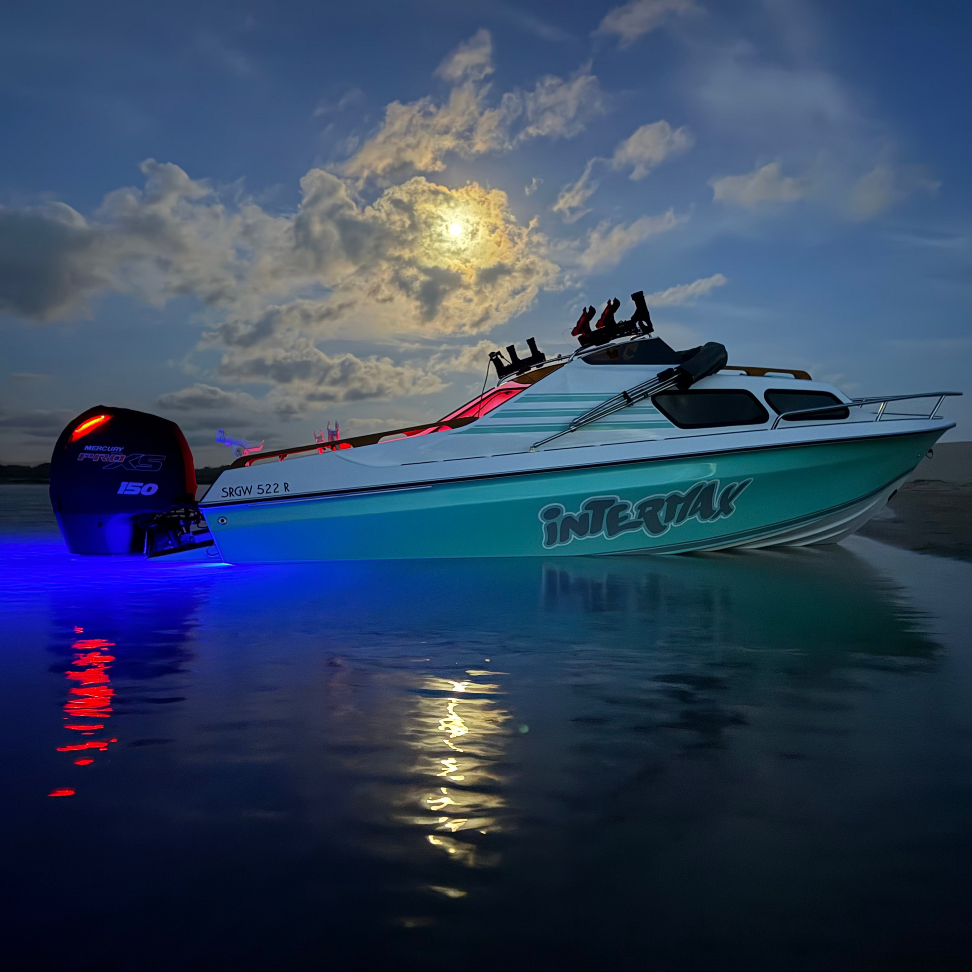 Boat on water at night with colorful lights