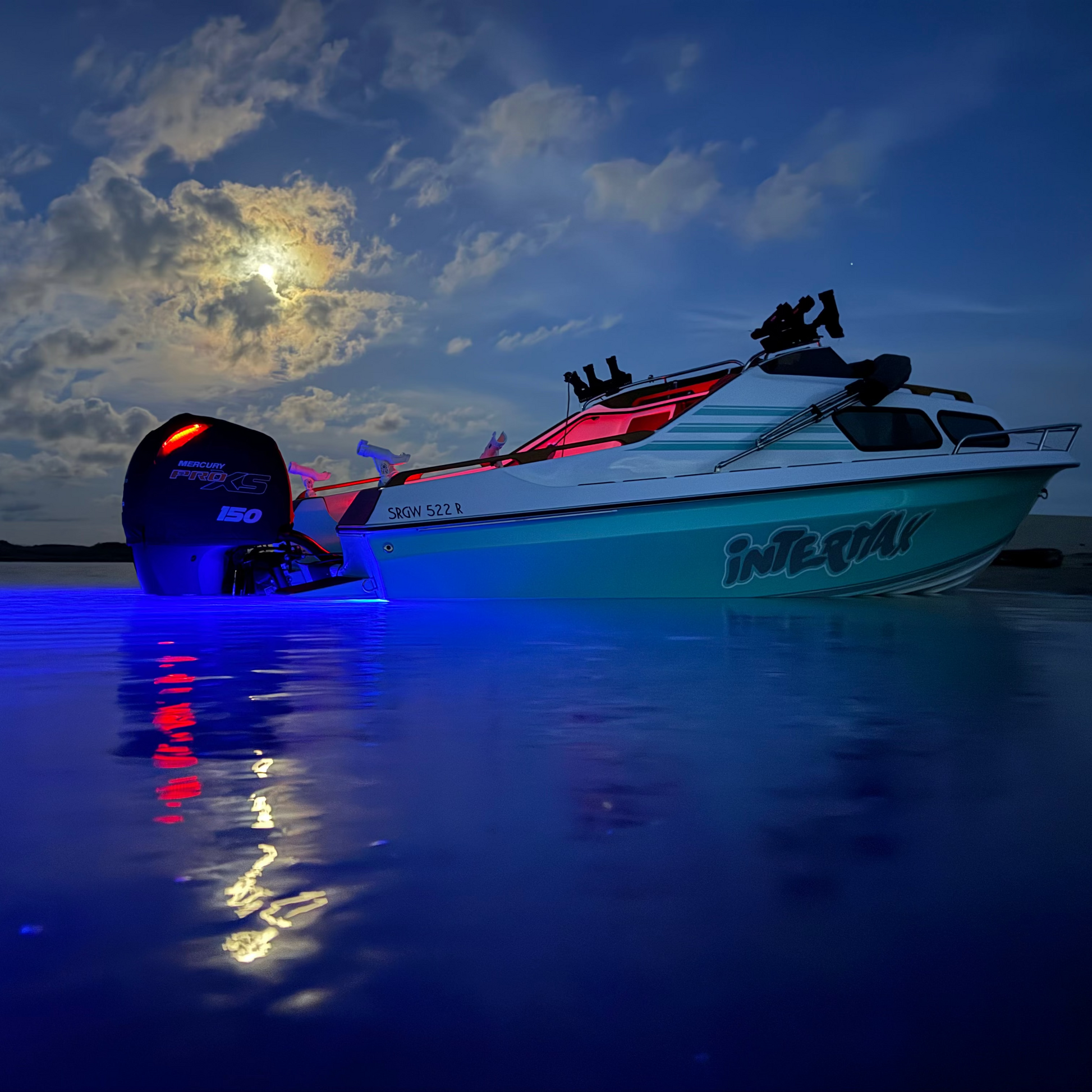 Boat on water at night with colorful lights