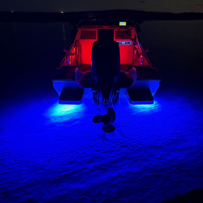 Boat on a sandy beach at night with red and blue lights