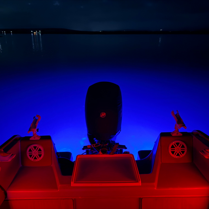 Boat with red lights on a dark water surface