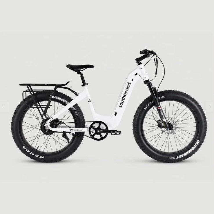 A white Southbound electric fat tire bike with black components, shown from a side profile against a light gray studio background.