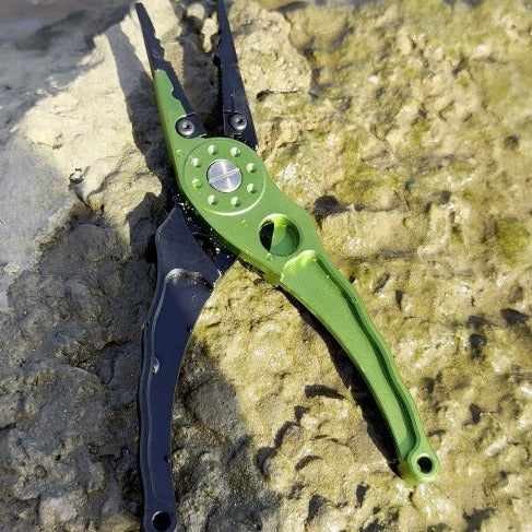 Salt ease fit pliers in green on a rock at gamtoos