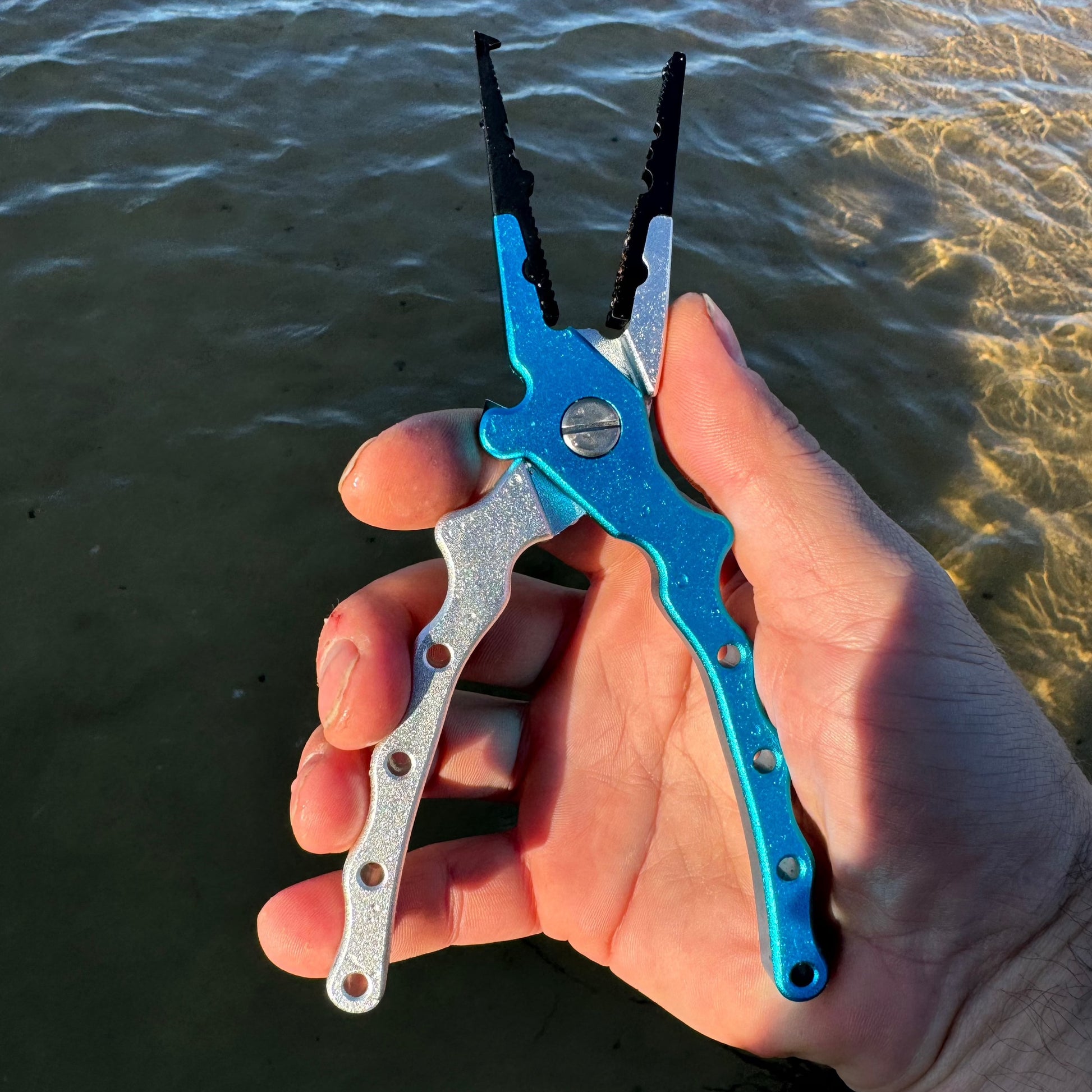 Salt grip fit pliers in blue in hand operation