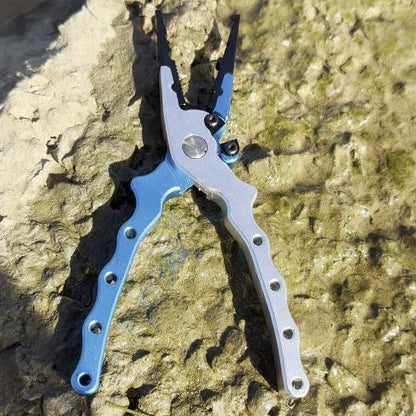 Salt grip fit pliers in blue on a rock at gamtoos