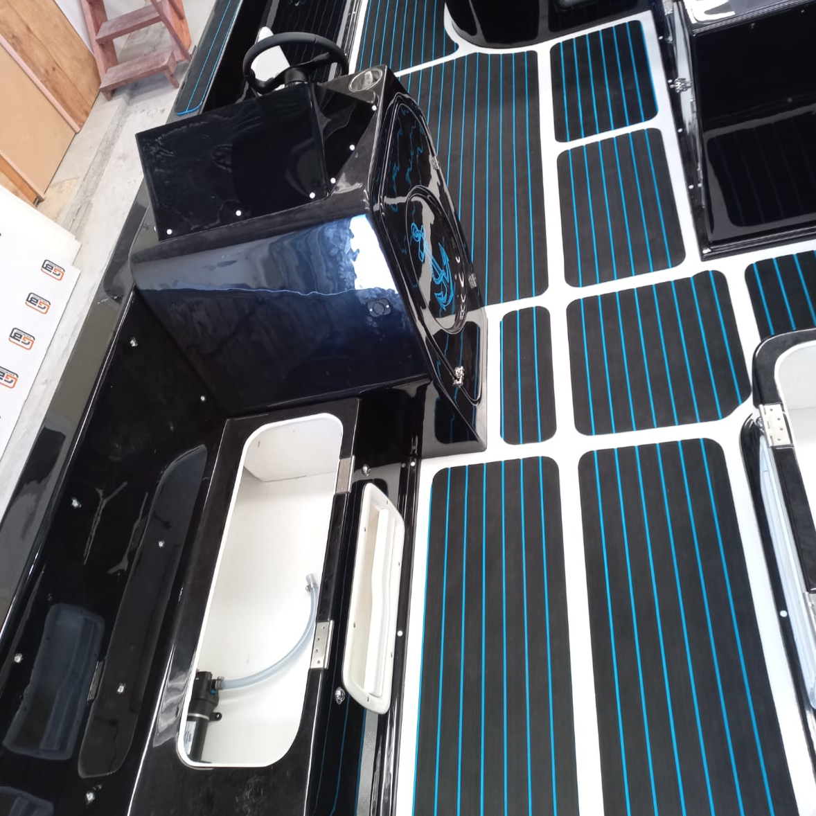 Blue and black EVA decking installed on a custom boat deck