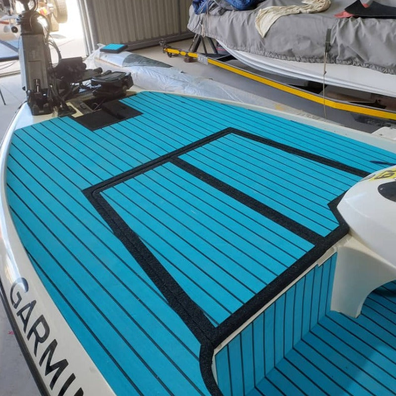 Blue EVA decking installed on a bass boat casting deck with custom hatch covers and non-slip marine flooring