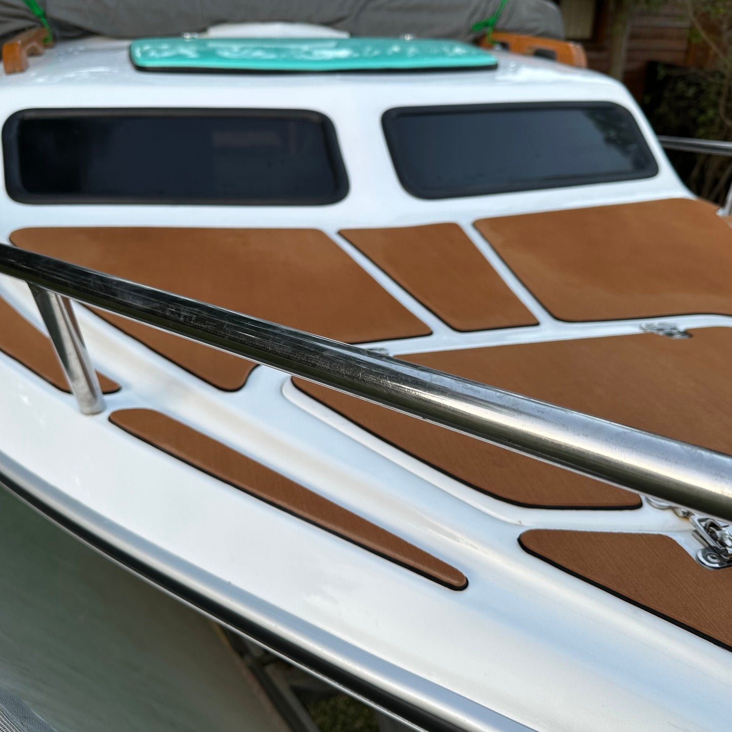 Brown EVA decking installed on a boat cabin roof and side decks