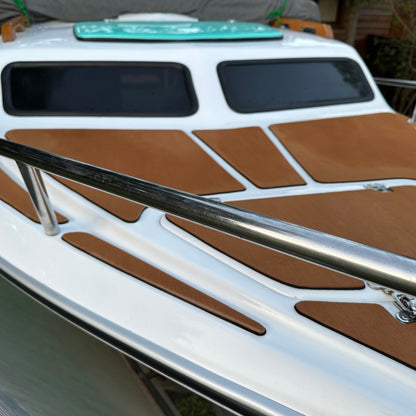 Brown EVA decking installed on a boat cabin roof and side decks