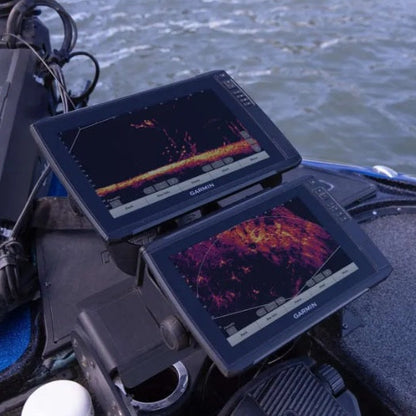 Dual Garmin fishfinders displaying LiveScope sonar mounted on a fishing boat, providing real-time underwater imaging to help anglers locate fish and structure.