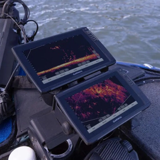 Dual Garmin fishfinders displaying LiveScope sonar mounted on a fishing boat, providing real-time underwater imaging to help anglers locate fish and structure.