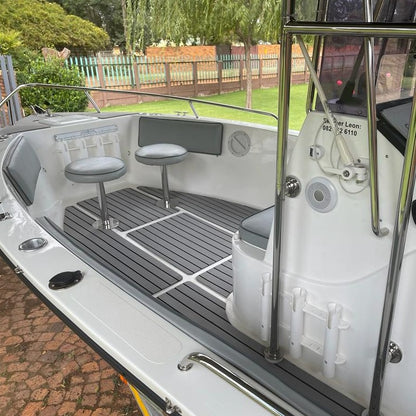 Grey and black EVA decking installed in a boat cockpit
