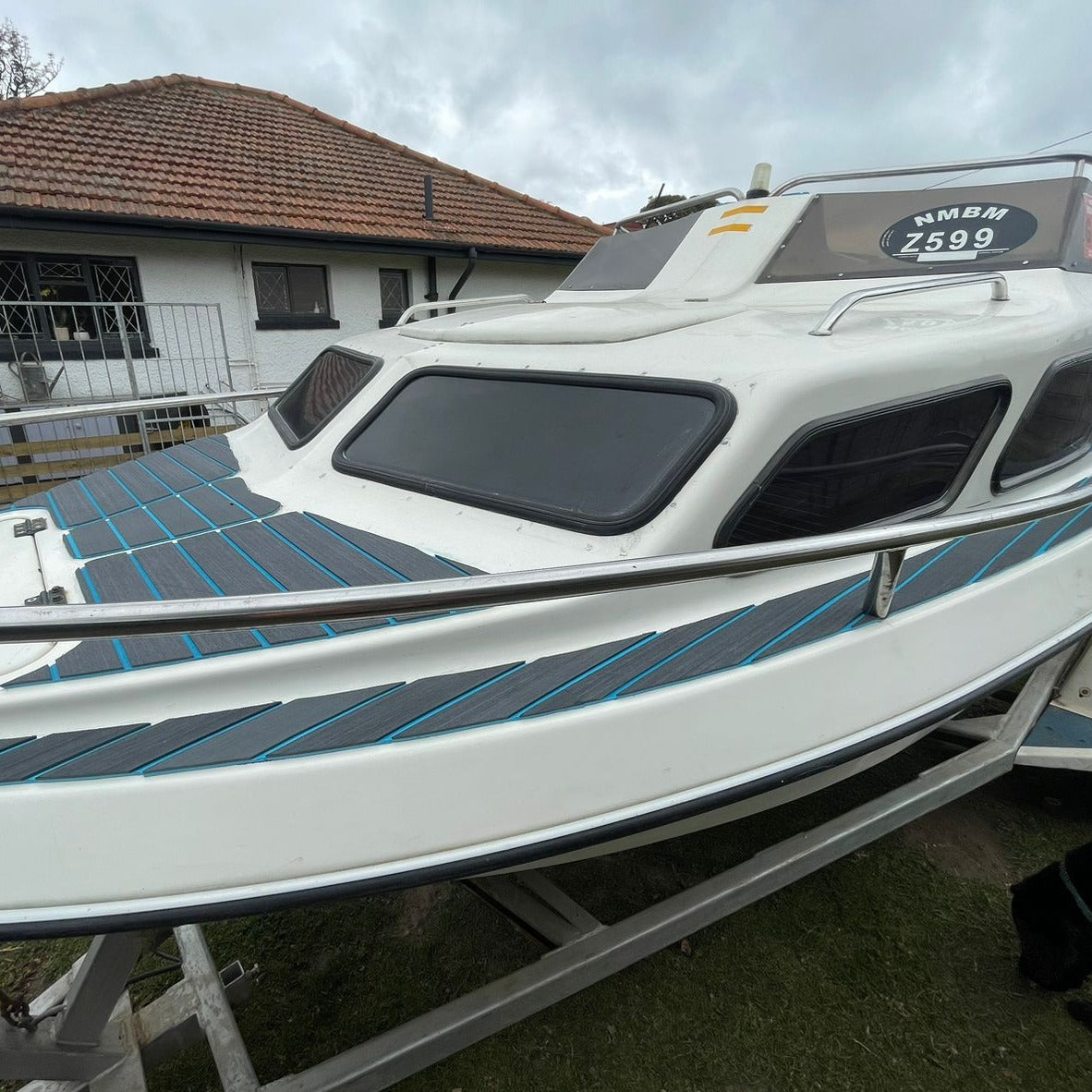 Grey and blue EVA decking installed on a cabin boat roof and side decks
