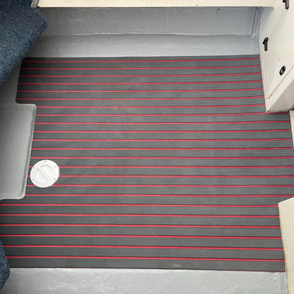 Grey and red EVA decking installed on a boat floor with straight line grooves