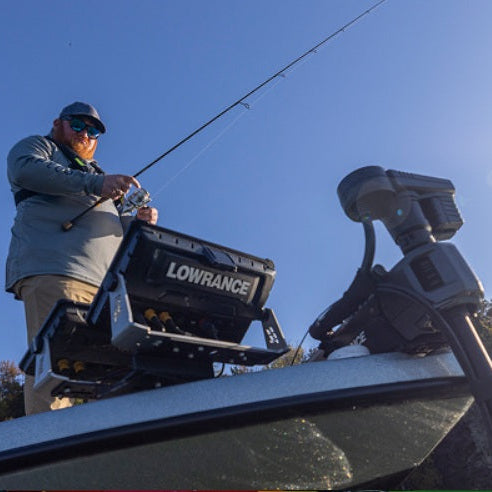 Angler fishing from a boat equipped with Lowrance ActiveTarget live sonar and fish finder technology for real-time fish tracking and underwater imaging.