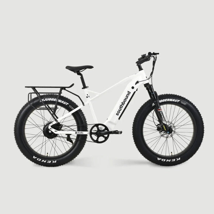 White Southbound fat tyre electric bicycle with rear cargo rack, integrated battery and wide all-terrain tyres built for beach riding, gravel roads and outdoor adventures.