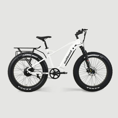 White Southbound fat tyre electric bicycle with rear cargo rack, integrated battery and wide all-terrain tyres built for beach riding, gravel roads and outdoor adventures.