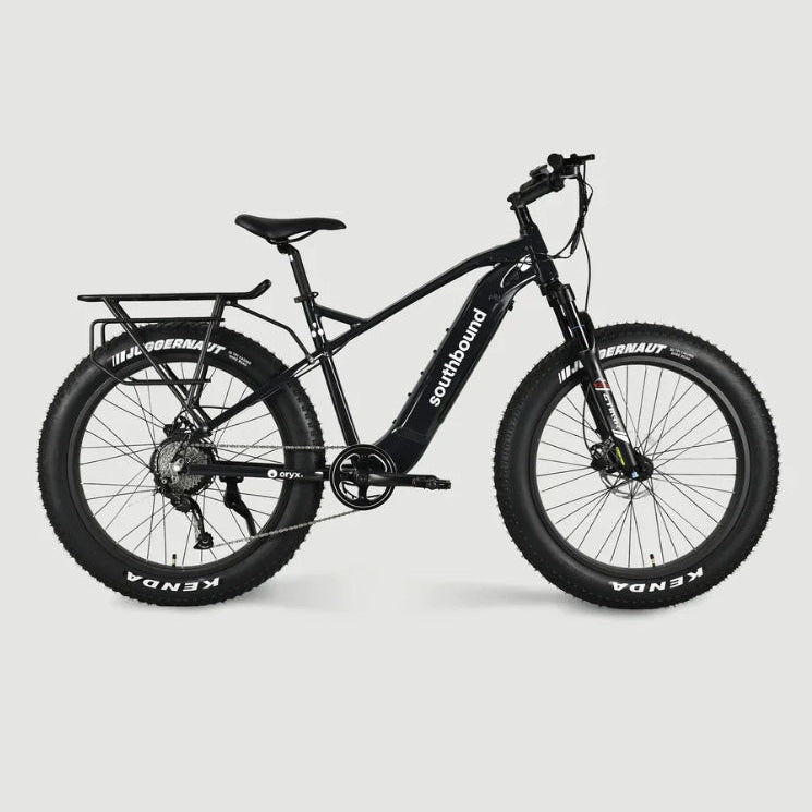 Southbound fat tyre electric bicycle with rear cargo rack, integrated battery and wide all-terrain tyres for beach riding, gravel roads and outdoor adventures.